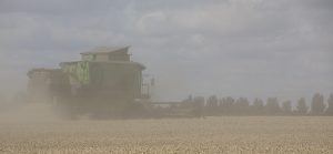 Combine harvester working away from photographer