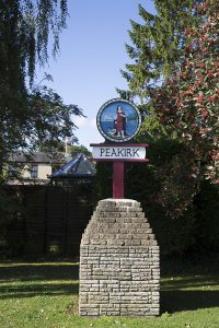 Peakirk sign in centre of village